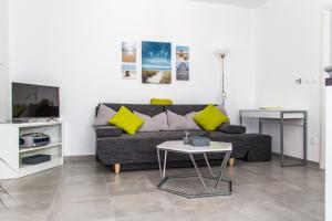 a living room with a couch and a table at Apartmani Žorić in Punat