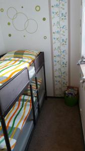 a bedroom with a bunk bed with a colorful bedspread at Haus Isabelle EG in Sankt Andreasberg