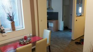 a dining room with a red table and chairs at Haus Isabelle EG in Sankt Andreasberg