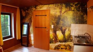 a kitchen with a painting on the wall at Das Haus am Hang in Schwäbisch Hall