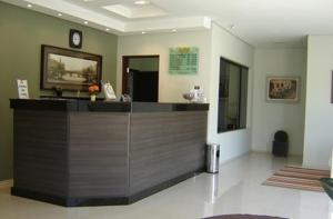 a lobby with a reception desk in a building at Hotel JWF in Piedade