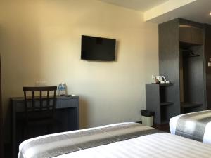 Postel nebo postele na pokoji v ubytování Check Inn Hotel Tawau