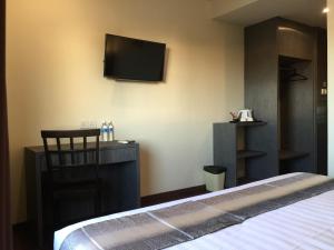 Postel nebo postele na pokoji v ubytování Check Inn Hotel Tawau