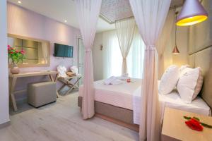 a bedroom with pink curtains and a desk and a bed at Lobelia Luxury Suites in Chrysi Ammoudia +225 photos