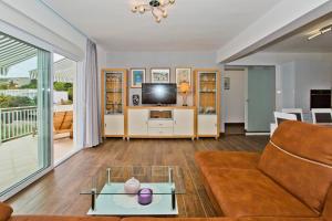 a living room with a couch and a tv at Apartments Grgo in Hvar