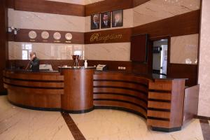 a lobby with a reception desk in a building at Rojina Hotel in Amman