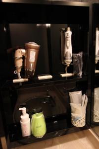 a black shelf with several different items on it at Lala Fleur (Adult Only) in Osaka