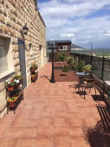 a patio with benches and a table and a building at Tuscany get-away apartment in Daverat