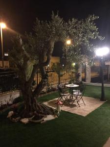 a table and chairs next to a tree at night at Tuscany get-away apartment in Daverat