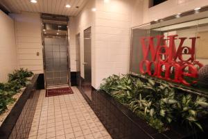 a hallway of a building with a red sign on the wall at Lala Fleur (Adult Only) in Osaka +2 photos