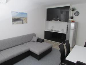 a living room with a couch and a sink at Sunset1, free private parking, pets welcome in Privlaka