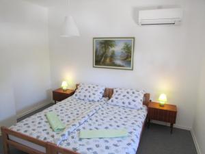 a bedroom with a bed and two lamps on two tables at Sunset1, free private parking, pets welcome in Privlaka