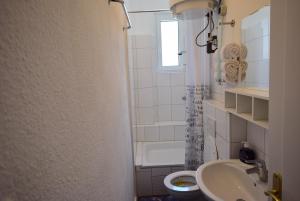 a bathroom with a sink and a toilet and a window at Apartment Ostendplatz in Stuttgart