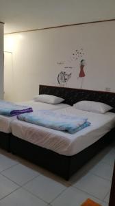 A bed or beds in a room at Pangkor Home Sea Village