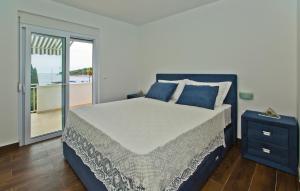a bedroom with a large bed and a balcony at Apartments Grgo in Hvar
