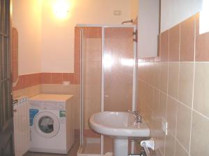 a bathroom with a sink and a washing machine at L' Arnia in Ome +41 photos