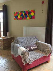 a bed with two pillows on it in a room at Le Valdine in Jemeppe