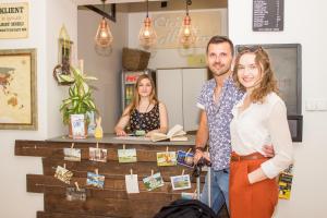 a man and a woman standing in front of a counter at Chillout Hostel in Warsaw