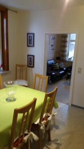 a green table and chairs in a living room at Haus Isabelle OG in Sankt Andreasberg