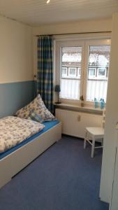 a small bedroom with a bed and a window at Haus Isabelle OG in Sankt Andreasberg +8 photos
