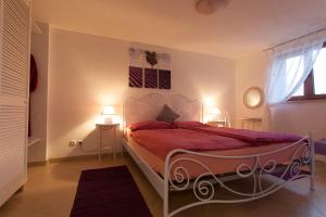 a bedroom with a bed with red sheets and a window at Villa Mir in Polje +123 photos