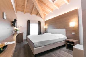 Postel nebo postele na pokoji v ubytování Hotel Operà