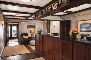 a living room with a large kitchen with a bar at King's Port Inn in Kennebunkport