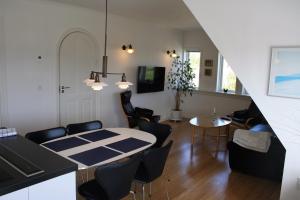 a kitchen and living room with a table and chairs at Østre Strandvej 49 in Skagen