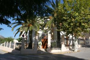 a house with a fence and trees on a street at Hotel Restaurante Casa Julia in Parcent