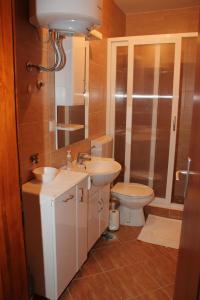 a bathroom with a sink and a toilet and a mirror at Guesthouse Vujacic in Cetinje +11 photos