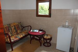 a living room with a couch and a table and a window at Guesthouse Vujacic in Cetinje