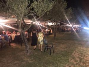 two women walking through a garden at night at Agriturismo Il Giriatello in Crotone