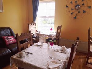 a dining room with a table and chairs and a window at The Creggs in Ballyvaughan