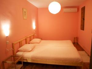 a bedroom with a bed with an orange wall at El Corrillo in Trevejo
