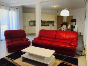 a living room with a red couch and a table at Casale a Figa Bianca in Patrimonio +27 photos
