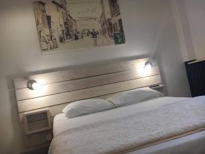 Postel nebo postele na pokoji v ubytování Hotel Le Centre