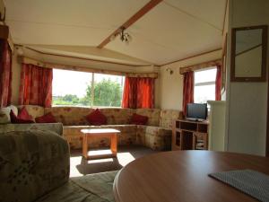 a living room with a couch and a table at Fenlake holiday accommodation in Metheringham