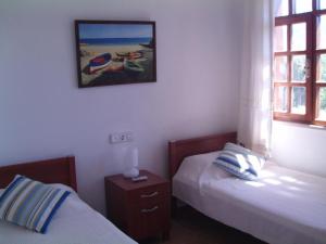 a bedroom with two beds and a picture on the wall at Villa Mercan in Datca