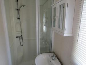 a bathroom with a shower and a sink at Fenlake holiday accommodation in Metheringham