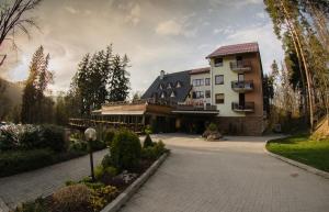 a large building with a driveway in front of it at Hotel Termál in Vyhne