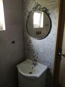 a bathroom with a sink and a mirror at Domki Letniskowe Gris in Grzybowo +50 photos