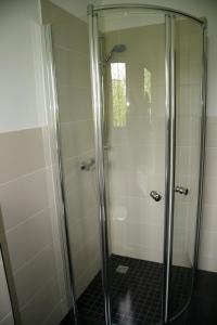 a shower with a glass door in a bathroom at Ferienwohnung Kiel-Russee in Kiel