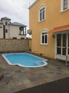 a swimming pool in front of a house at Sunile Villa in Flic-en-Flac
