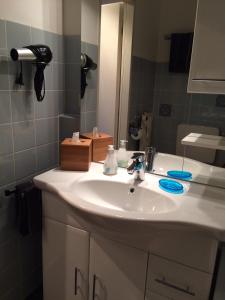 a bathroom with a white sink and a mirror at Klein und fein in Oberstaufen