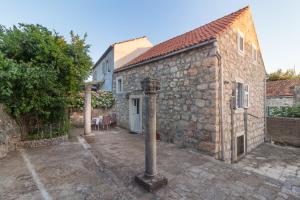 a stone building with a pole in front of it at Apartment Sokol in Dubrovnik