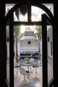 uma vista para um quarto com uma mesa e cadeiras em Riad First em Marrakech