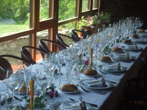 a long table with glasses and plates on it at Masia d'en Valentí in Anserall