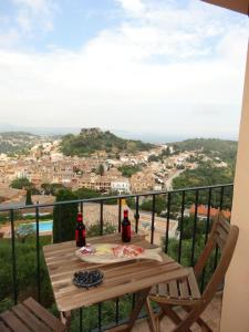 a table with two bottles of wine on a balcony at Mirador De Begur in Begur