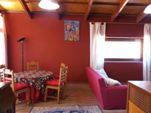 a dining room with red walls and a table and chairs at Casas de Canavezes in Marco de Canaveses