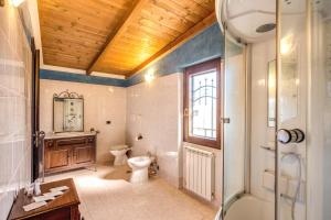 a bathroom with a toilet and a sink and a shower at Villa Gengi in Ardea +37 photos